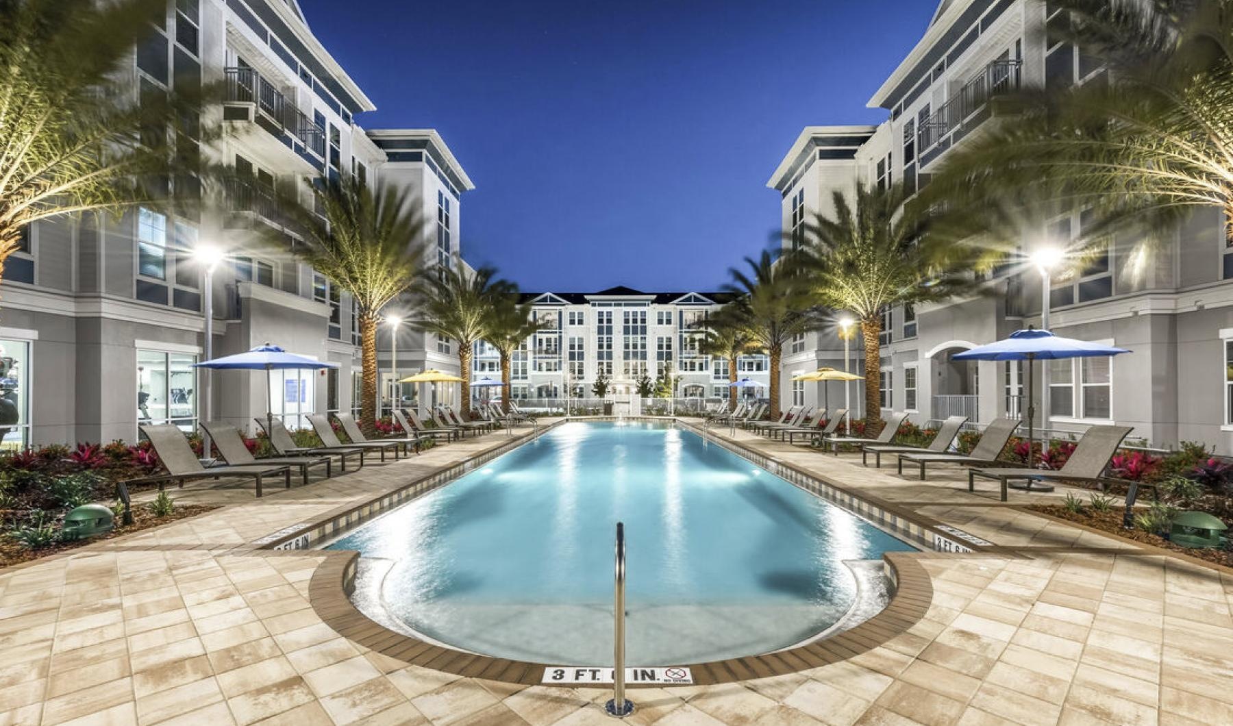 a pool in a courtyard between buildings