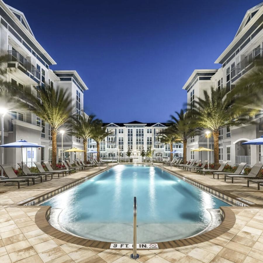 a pool in a courtyard between buildings